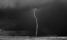 Photograph of lighting bolt coming down from clouds