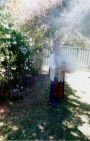 photo of aboriginal person doing a traditional smoking ceremony