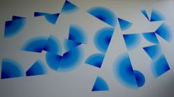 a series of blue geometric shapes painted on a white wall