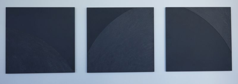 3 dark glass squares with slight half-moon shaped engraving on each