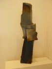 vertical irregular ceramic structure with iridescent colour at the to and black at the bottom