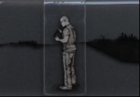 glass rectangle artwork with black shapes either side a man