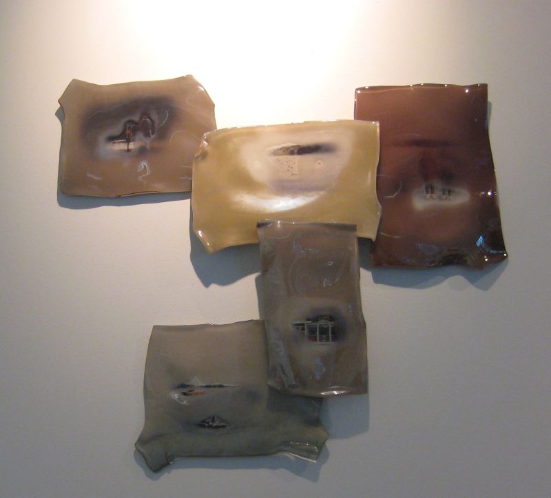 5 blown glass panels arranged in an upside down pyriamid (irregular) with faded painted scenes on each one, as if too mimic a memory