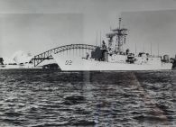 Photograph of HMAS Canberra I in 1930 in front of the Sydney Harbour Bridge