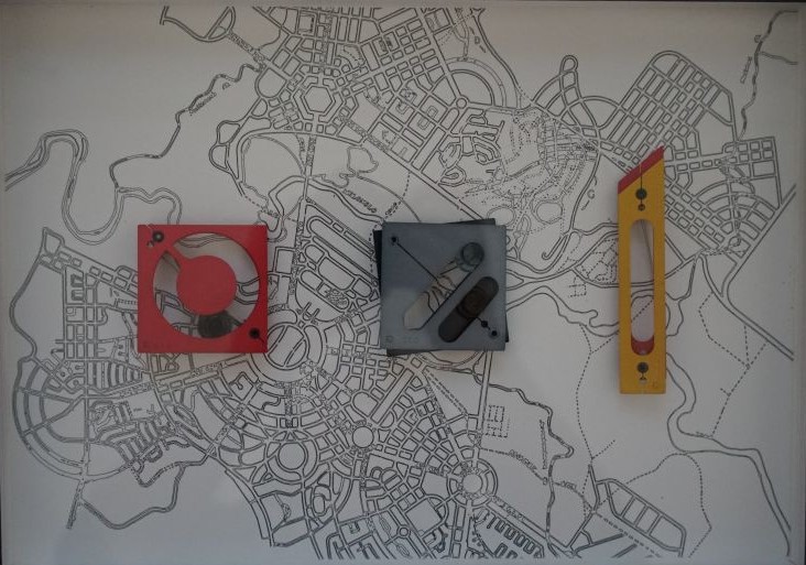 map of Canberra with 3 objects on top - red square with circle cut out, black square with line cut out and yellow rectangle shaped like a Stanley knife