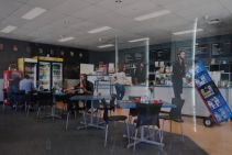 edited photograph of man with disability working in a cafe in multiple roles